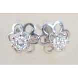 A pair of ladies white gold and diamond earrings - studs complete with the posts,