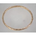 A hallmarked 9ct gold bangle bracelet with hidden clip clasp. Hallmarked Sheffield. Weight 10.