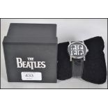 The Beatles - A boxed The Beatles collectors watch featuring all four band members pictured to the
