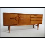 A 1970's retro Danish influenced teak wood sideboard raised on tapered legs with wide bow front