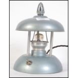 A 1930's Art Deco night light having enamel painted frame with chrome swivel finial controlling