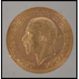 Coins. A George V gold Sovereign, 1929, St George and the Dragon to verso. Total weight 7.