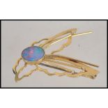 A 9ct gold and opal ladies brooch in the form of a dragonfly.