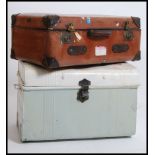 A vintage metal steamer / tack trunk having a hinged top together with a good leather travel trunk