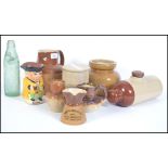 A collection of 19th and 20th century Bristol stoneware's to include harvest jugs, bed warmer,