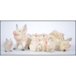 A collection of five ceramic Beswick Pigs to include Piggy back pig and piglet 2746, Pig 832,