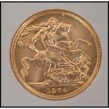 Coins. An Elizabeth II gold Sovereign, 1974, St George and the Dragon to verso. Total weight 8.