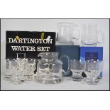 A boxed retro Dartington crystal seven piece water set consisting of six glasses and water jug