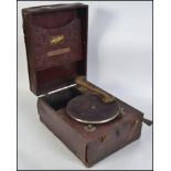 A vintage early 20th century portable wooden cased vinyl covered gramophone.