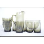 A good retro Scandinavian style lemonade set consisting of a ewer and six glasses in smoked glass