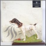 A Royal Doulton ceramic figure of a Pointer dog set on a naturalistic plinth with wooden plinth