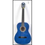 A 20th century Stagg acoustic six string Spanish style guitar finished in blue with carry bag.