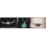 A group of jewellery items to include an amber ? pendant on a silver chain,