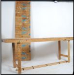 A pair of long mid century retro Industrial trestle tables of solid wood construction with planked