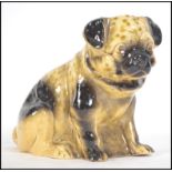 A ceramic 19th century Victorian Staffordshire figurine of a Pug dog.