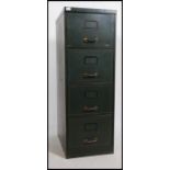 A 1950's mid century green metal 4 drawer filing cabinet with coachlined detail to the drawer