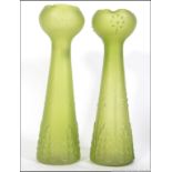 A pair of oversized green glass hyacynth