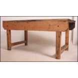 A large mid 20th century Industrial type scratch built pine four plank workbench / table having