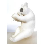 A carved white marble figurine of a pand