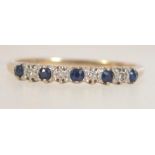 A hallmarked 9ct gold sapphire and diamond half eternity ring. Import marks for Birmingham. Size P.