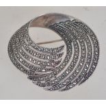 A 925 silver Art Deco Style swirl brooch set with marcasite with roller clip clasp. Weight 18.9g.