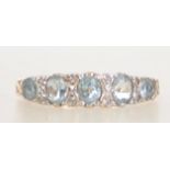 A vintage hallmarked London 9ct gold ring with 3 blue oval cut topaz with illusion set diamonds and