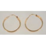 A pair of 9ct gold hoop earrings with etched star decoration and lever clasp backs. Marked 375.