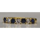 A hallmarked 18ct gold, blue sapphire and diamond ring. Hallmarked for London.