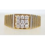 A hallmarked 18ct gold and diamond ring with ribbed tapering shoulders in the manner of Rolex with