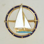 An Art Deco style hallmarked 9ct gold and enamel figural brooch of a sailing boat within a circular
