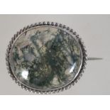 A Victorian silver mounted moss agate brooch with c clasp. Measures approx 1.5 inches.