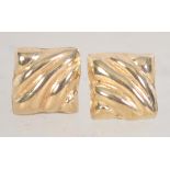 A pair of 9ct gold stud earrings with scalloped decoration with post backs. Test 9ct gold.