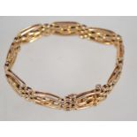 A 9ct gold bracelet of bar link form complete with the safety chain. Measures 7 inches. Weight 12.