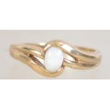 A hallmarked 9ct gold and opal ring with pierced crossover design with oval opal. Size P. Weight 2.