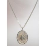 A hallmarked 925 silver locket pendant necklace with rope twist surround engraved flowers and
