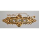 A hallmarked 15ct gold and diamond Victorian bar brooch set with three diamonds,