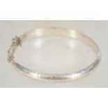 A vintage hallmarked 925 silver bangle bracelet with foliate engraving.