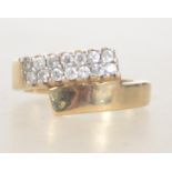 A 9ct gold hallmarked Birmingham dress ring set with clear pave set stones in an overlapping twin