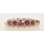 A Victorian hallmarked Chester 1895 9ct gold ring with 5 garnet stones in a gypsy setting. Size L.