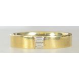 A hallmarked contemporary 18ct gold and diamond band ring,