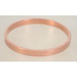 A hallmarked 9ct rose gold slave bangle bracelet.