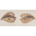 A pair of 9ct gold stud earrings with in the form of leaves with post backs. Marked 9ct.