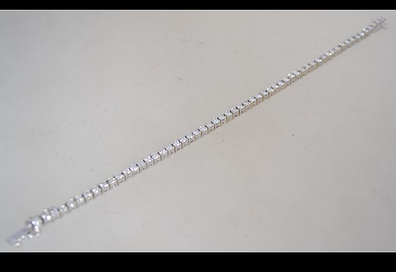 A hallmarked 18ct white gold and diamond tennis bracelet set with a total of 3cts diamonds. - Image 6 of 8