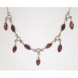 A 925 silver garnet glass and pearl festoon necklace. Marked 925. Measures 18 inches. Weight 12.