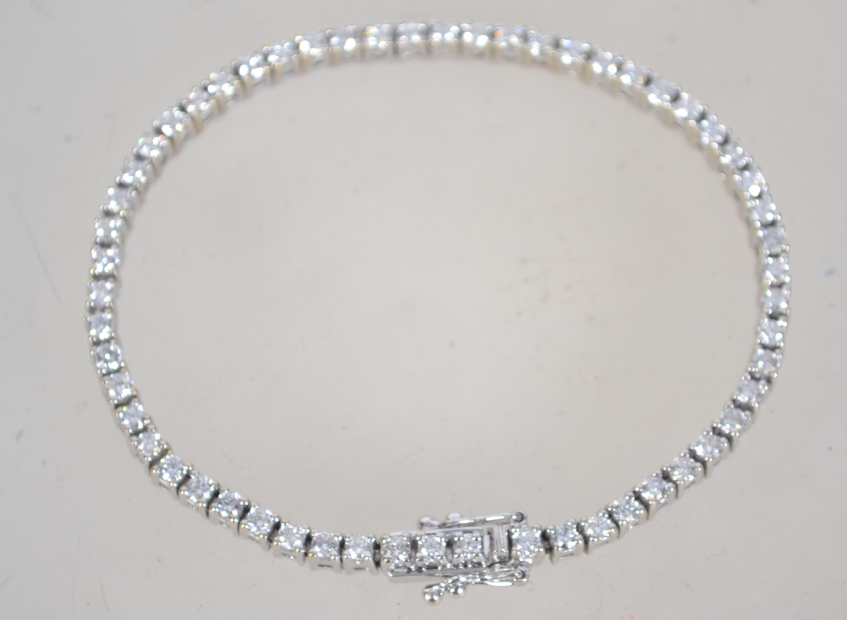 A hallmarked 18ct white gold and diamond tennis bracelet set with a total of 3cts diamonds.