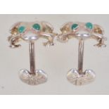 A pair of contemporary 925 silver figural cufflinks in the form of frogs with green gem eyes.