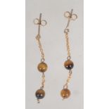 A pair of 9ct gold drop earrings with tigers eye beads post backs. Test 9ct gold. Measure 3cms.