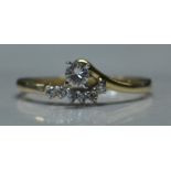 A 14ct gold and diamond ring with approx 15pts diamonds in a crossover setting.