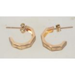 A pair of 9ct gold hoop earrings with etched star decoration and post backs. Tests 9ct gold.