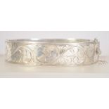 A vintage hallmarked 925 silver bangle bracelet with foliate engraving.